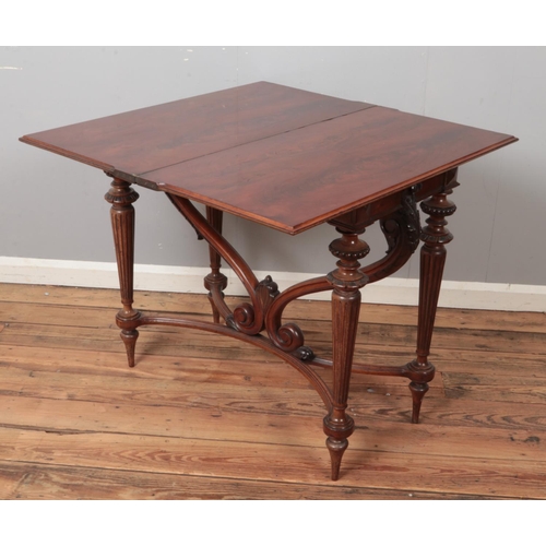 499 - A carved mahogany fold over tea table. Raised on scrolled support and reeded tapering legs. (78cm x ... 