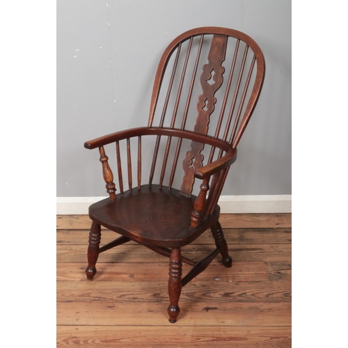 502 - A 19th century ash/elm windsor arm chair with pierced back decoration.