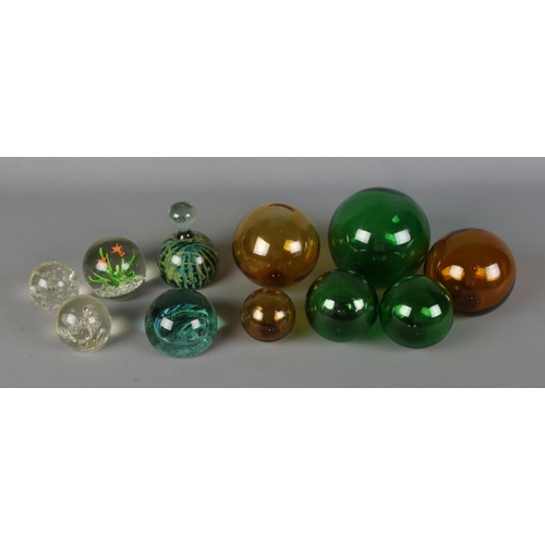 252 - A small quantity of hand blown glass fishing balls of varying sizes along with small selection of pa... 