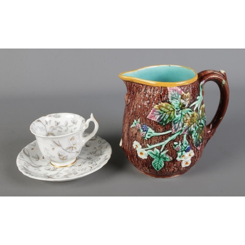 254 - A Rockingham tea cup and saucer pattern number 1300, bearing puce griffin to reverse along with a We... 