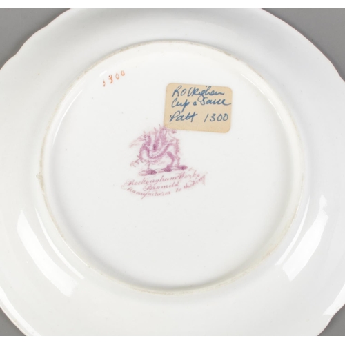 254 - A Rockingham tea cup and saucer pattern number 1300, bearing puce griffin to reverse along with a We... 