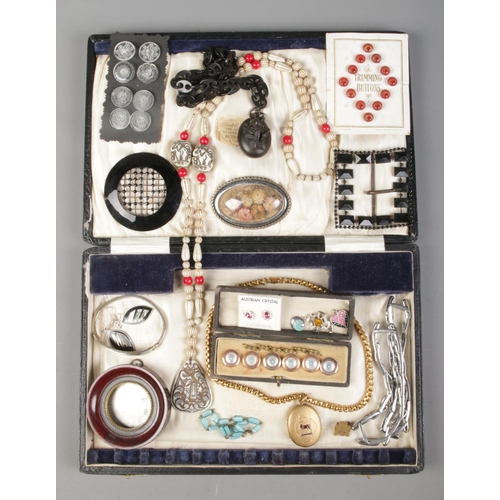 264 - A hinged cutlery box containing an assortment of costume jewellery, including cased buttons, hinged ... 