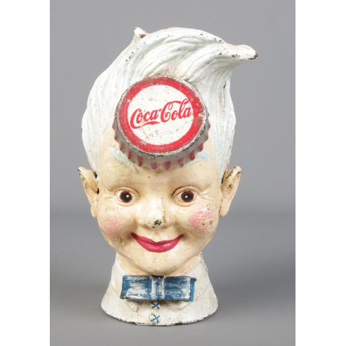 287 - A novelty cast iron Coca Cola money box. Height 20cm.