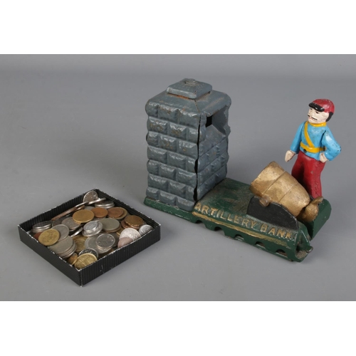 297 - A novelty cast iron money bank, Artillery Bank, along with a small quantity of world coins.