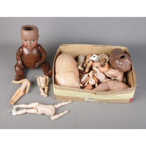 351 - A box of porcelain doll parts to include Simon and Halbig doll stamped 117 to reverse.