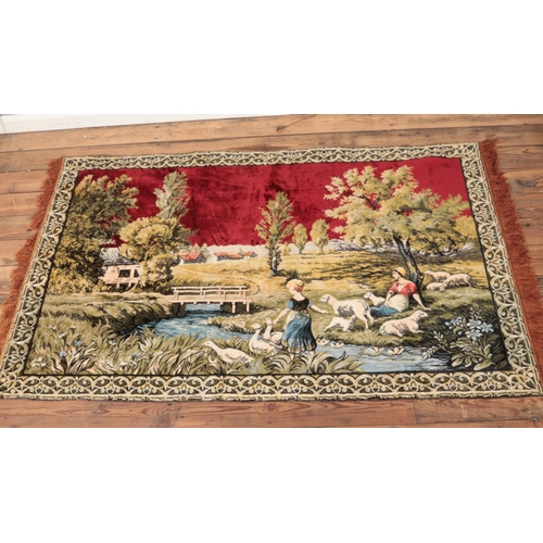 363 - A wool tapestry with frilled edges depicting two figures amongst geese and sheep within a farm, on b... 