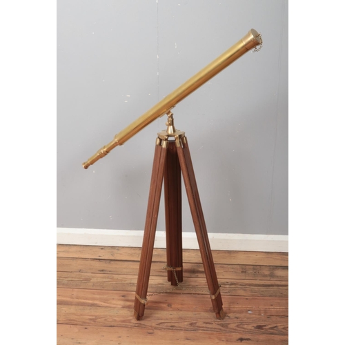 364 - A brass 19th century style telescope on brass mounted tripod.