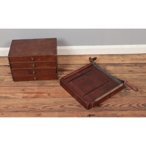 372 - A small set of four drawers along with a vintage guillotine.