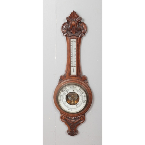 385 - A carved oak banjo aneroid wall barometer.