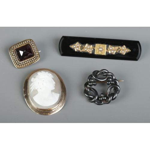 418 - A 9ct Gold mounted cameo brooch, together with three other Victorian brooches, one set with pearls.