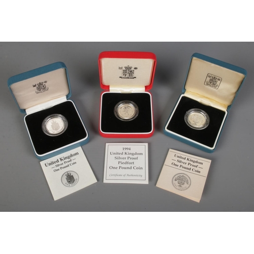 452 - Three cased Royal Mint silver proof one pound coins. Includes 1994 Piedfort example, etc.