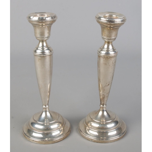 463 - A pair of weighted silver candlesticks. Assayed Birmingham 1922. Gross weight 443g.