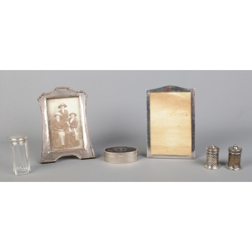 469 - A collection of silver mounted items, to include two photo frames, salt and pepper pots and glass ja... 