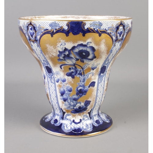 299 - A Losol Ware, Bourbon vase featuring gilt and blue floral decoration. 19.5cm tall.