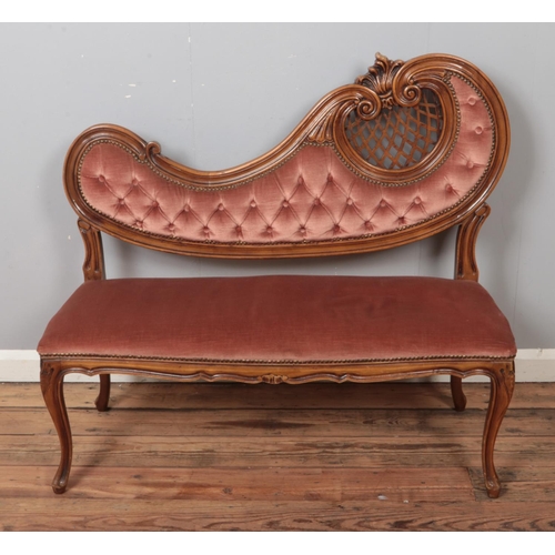 506 - A French style two seat parlour sofa with ornate carved wood decoration.