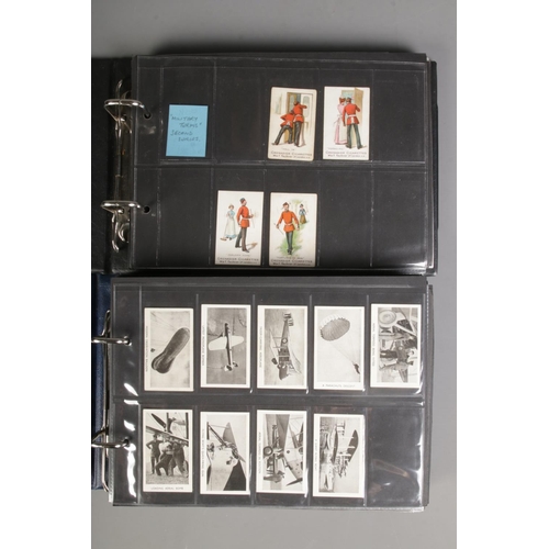 519 - Two folders of incomplete cigarette cards including Modern Armaments, Cairo 