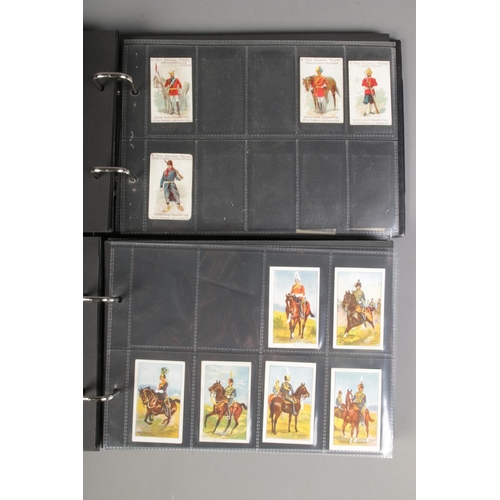 519 - Two folders of incomplete cigarette cards including Modern Armaments, Cairo 