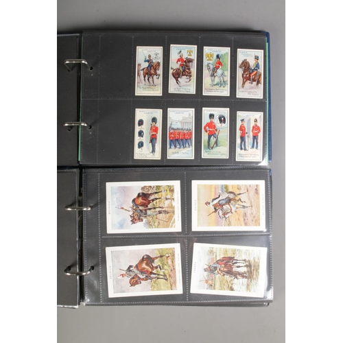 521 - Two folders of incomplete cigarette cards including Pritchard & Burton's 