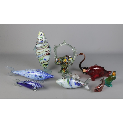 288 - A quantity of Murano glass style fish along with other glass examples and a glass swan and novelty a... 