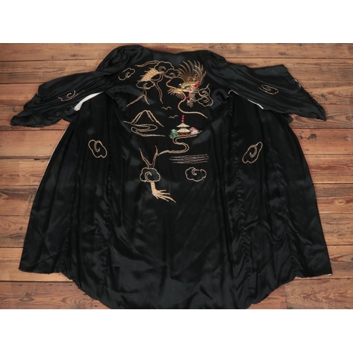 375 - A Japanese black silk Kimono with goldwork decoration depicting a dragon.