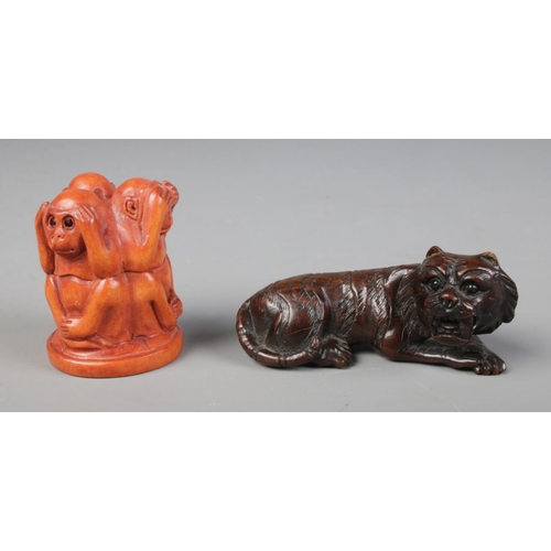 446 - Two hand carved hardwood netsuke one of a tiger and another of the three wise monkeys.