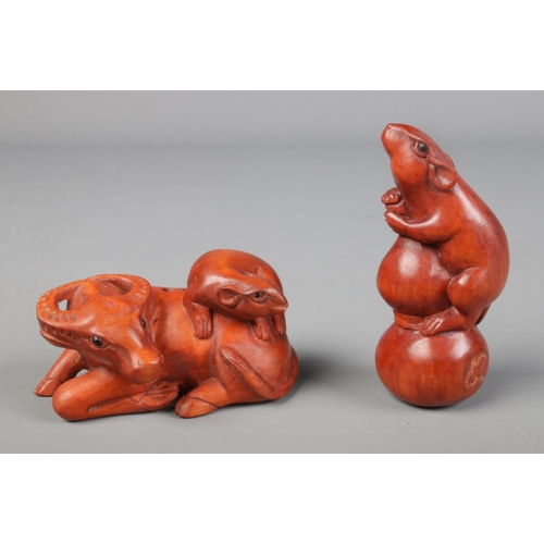 447 - Two hand carved hardwood netsuke of a mouse and a buffalo with a mouse sat on him.