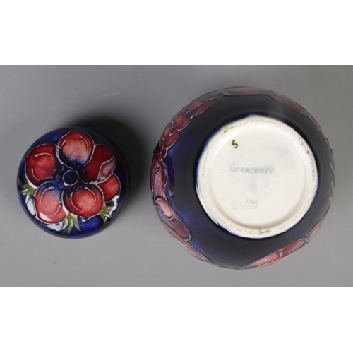 488 - A small Moorcroft pottery dark blue ground ginger jar with cover in the 'Anemone' design. With impre... 