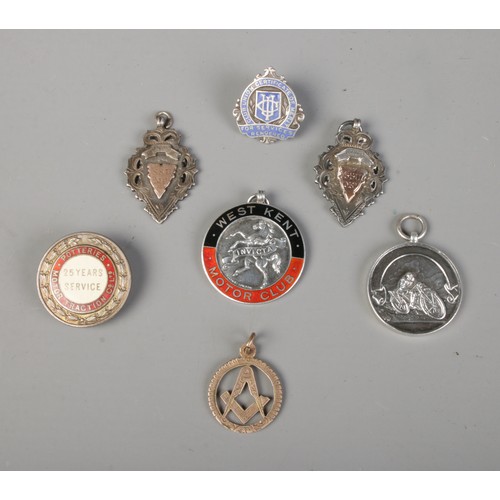 441 - A collection of silver fobs with masonic examples including one other example rose gold colour.