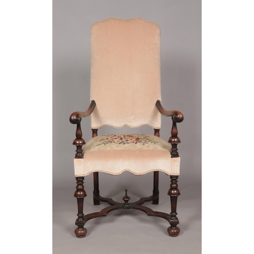 410 - An early 19th century carved walnut upholstered arm chair. Having x-frame stretcher with centre fini... 