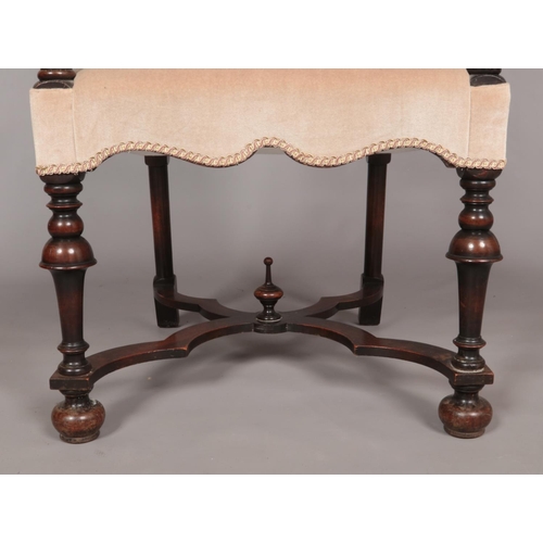 410 - An early 19th century carved walnut upholstered arm chair. Having x-frame stretcher with centre fini... 