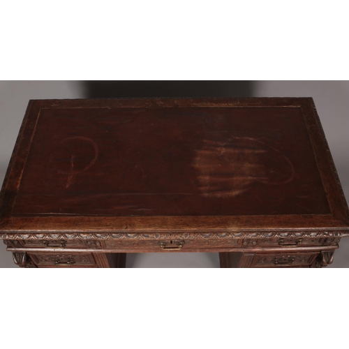 414 - A Victorian carved oak twin pedestal desk. Height 77cm, Width 140cm, Depth 77cm.