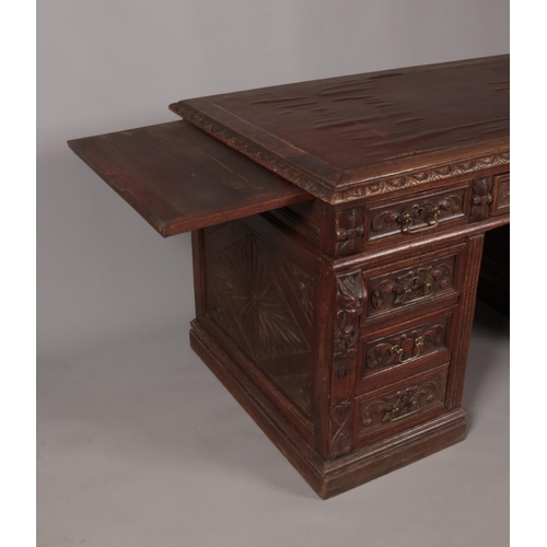 414 - A Victorian carved oak twin pedestal desk. Height 77cm, Width 140cm, Depth 77cm.