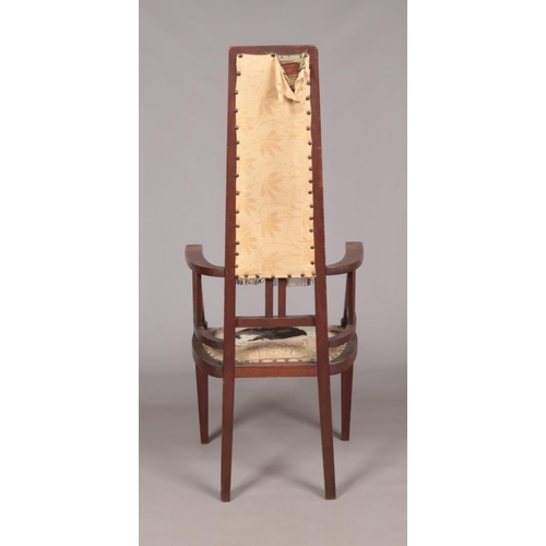 411 - An Arts & Crafts oak arm chair. Height of back 125cm.