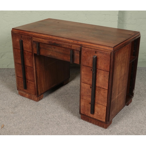 412 - An Art Deco mahogany desk with side storage shelves. 
(78cm x 114cm x 61cm)