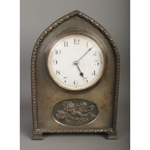 30 - A French white metal presentation mantel clock featuring cherub motif with French movement. Presenta... 