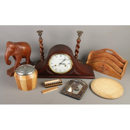 58 - A collection of treen. Includes Maxim mantel clock, barley twist candlesticks, carved elephant etc.