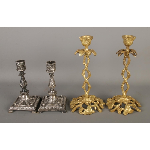 61 - Two pairs of ornately decorated candlesticks to include brass and silver plated examples. Tallest ex... 