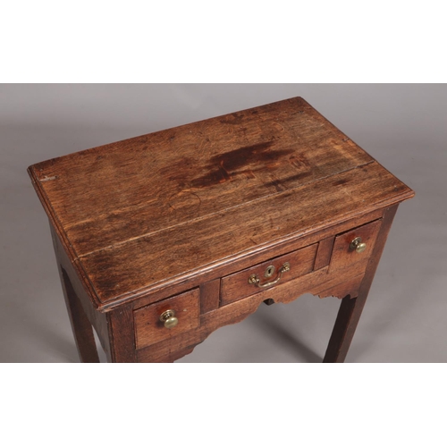 432 - A Georgian oak side table, having three drawers and raised on square cut legs. Height 75cm, Width 76... 