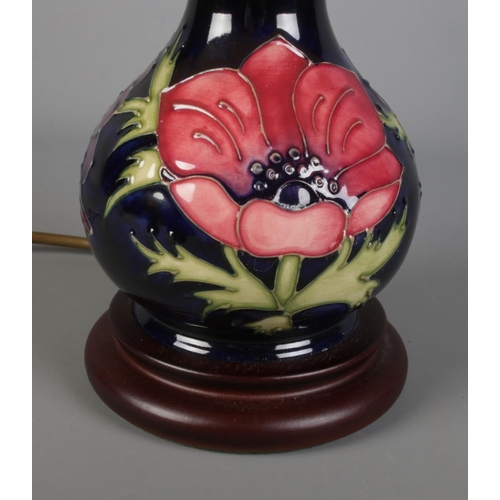 394 - A Moorcroft blue ground anemone pattern table lamp with shade. Approx. height without shade 20cm.