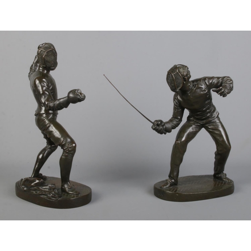 113 - After Benedict B Rougelet, a pair of bronze fencers, signed F Lombard. Height 28cm.