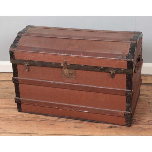 445 - A vintage dome top wooden bound trunk.