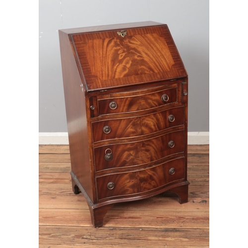 450 - A walnut bureau featuring leather inset writing slope, fitted interior and brass escutcheon with key... 