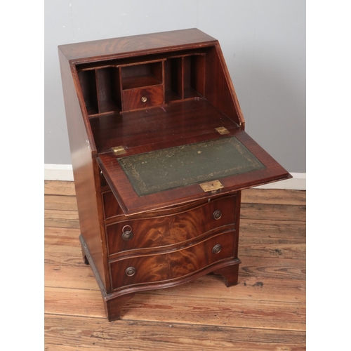 450 - A walnut bureau featuring leather inset writing slope, fitted interior and brass escutcheon with key... 