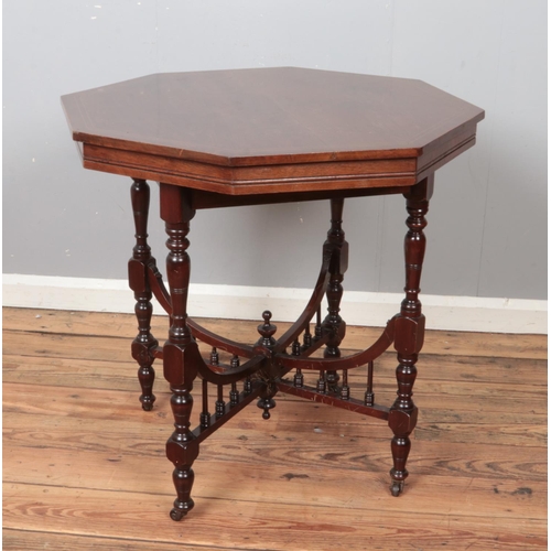 455 - A Victorian mahogany octagonal window table raised on turned supports.