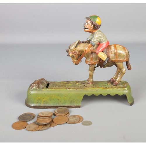 117 - A cast iron money box in shape of horse and jockey.