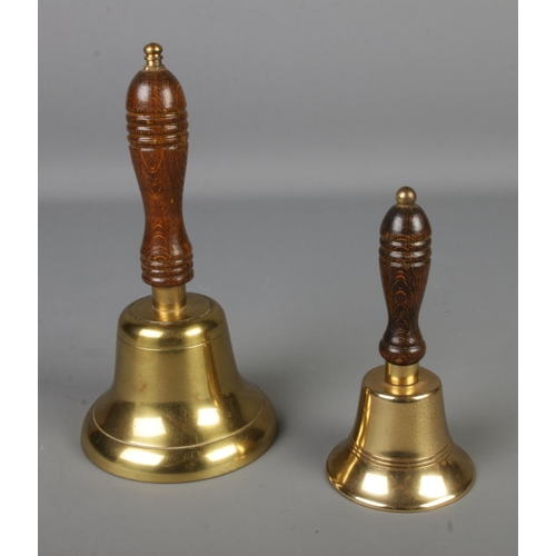 124 - Two brass and turned wood school bells, small bell has Lombard stick to inside.

Large bell Hx24.5cm