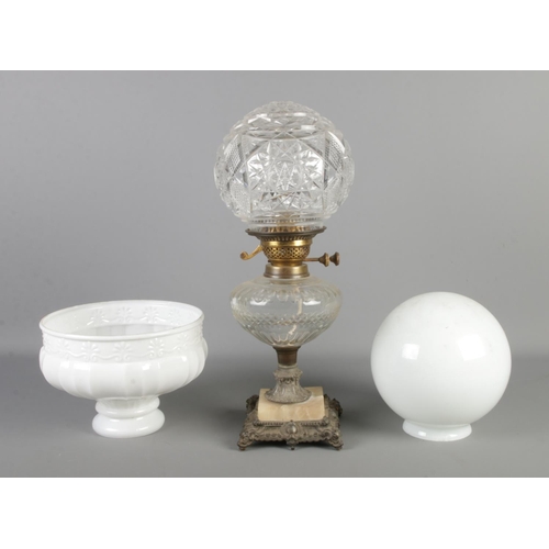 150 - A decorative glass bodied oil lamp (converted to electric), raised on stepped base, together with tw... 