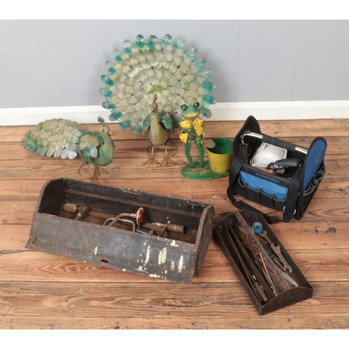 168 - A box of decorative metal garden ornaments along with selection of hand tools. Includes chisels, spa... 