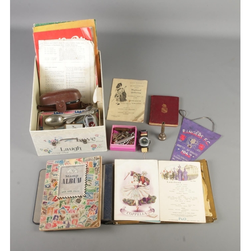 175 - A box of assorted collectables and ephemera to include 1960's cruise dinner menus, world stamps, cos... 