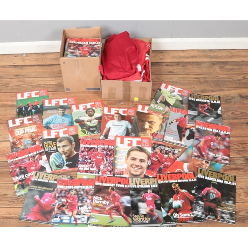 180 - Two boxes of early 2000s Liverpool FC football programmes along with eight Liverpool FC football shi... 